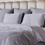 gray platinum and white geometric pattern duvet cover and matching pillowcases on a bed
