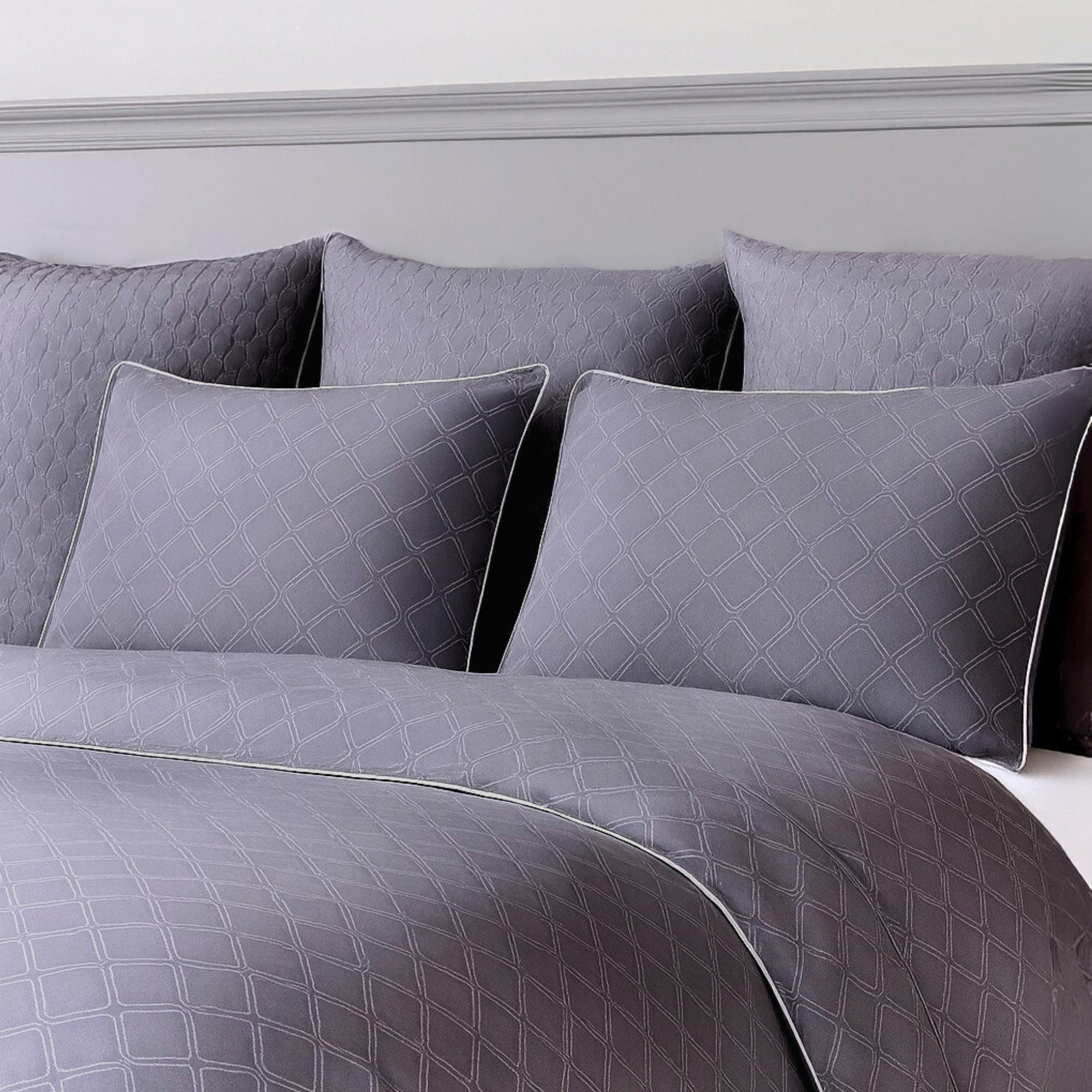 Gray patterned bamboo bedding set with pillows on a bed