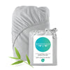 Gray fitted sheet with BEDVOYAGE packaging and a green leaf on a white background