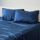 indigo bamboo pillowcases and sheet set on a bed