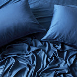 2 dark blue indigo pillowcases and flat sheet looking beautiful and shiny