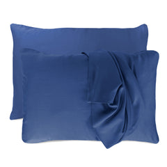 dark blue indigo pillowcases set with floating pillows and one pillowcase is draped over a pillow