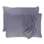 dark gray platinum pillowcases set with floating pillows and one pillowcase is draped over a pillow