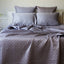platinum gray quilted bamboo coverlet on a bed with pillows