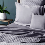 dark gray platinum quilted bamboo coverlet with sheet set and pillows on a bed