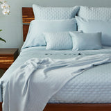 light blue sky bamboo quilted coverlet on an elegant bed with a bamboo blanket