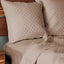 champagne tan quilted bamboo euro shams brick pattern on an elegant bed