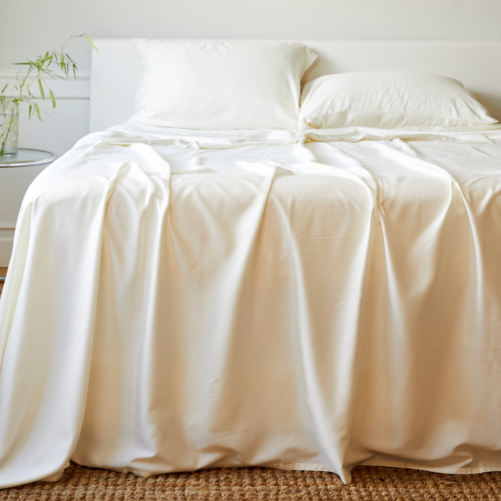 ivory bamboo sheet set and pillows on an elegant bed