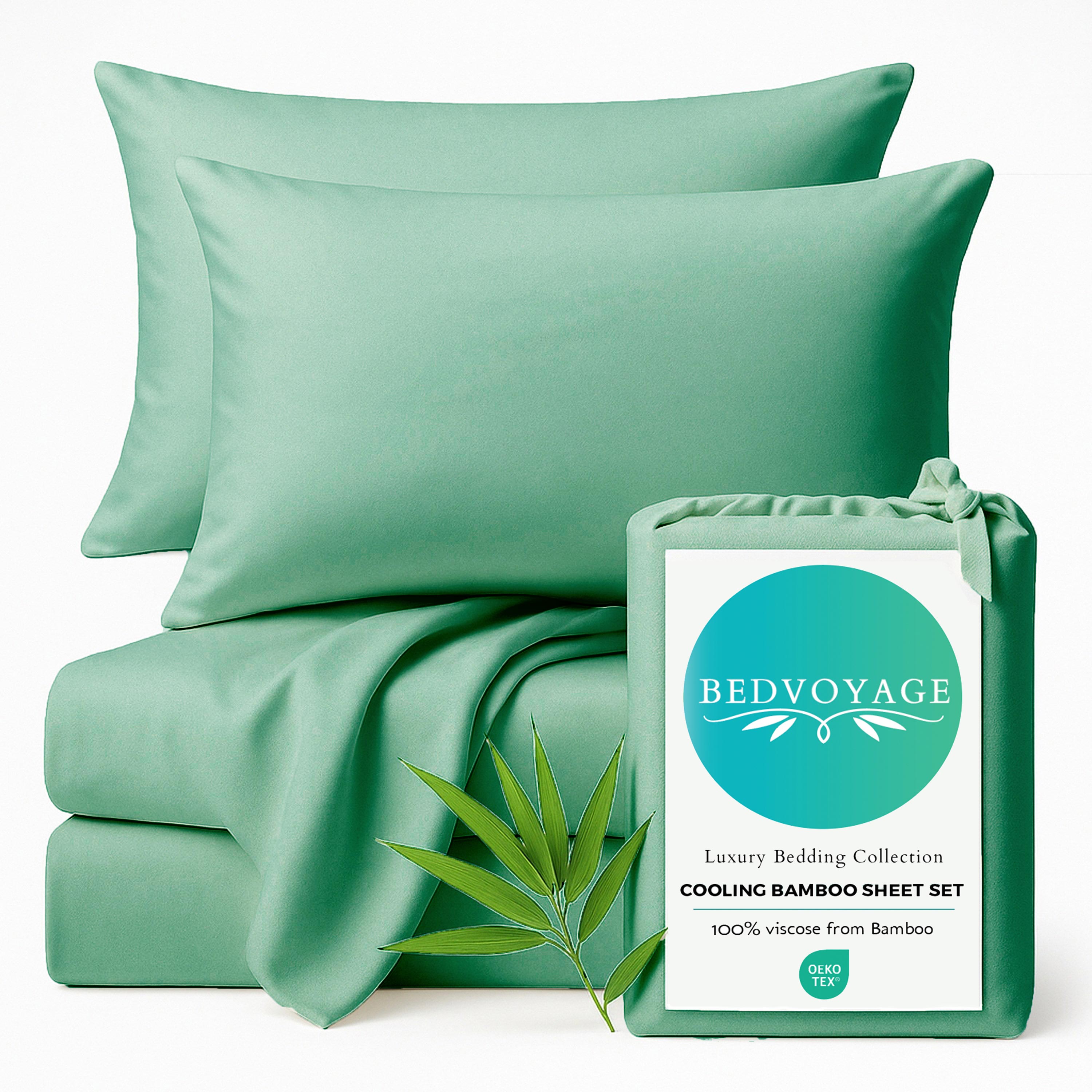 seaglass green bamboo bed sheets stack with pillows sitting on a white background with packaging bag and bamboo leaf 