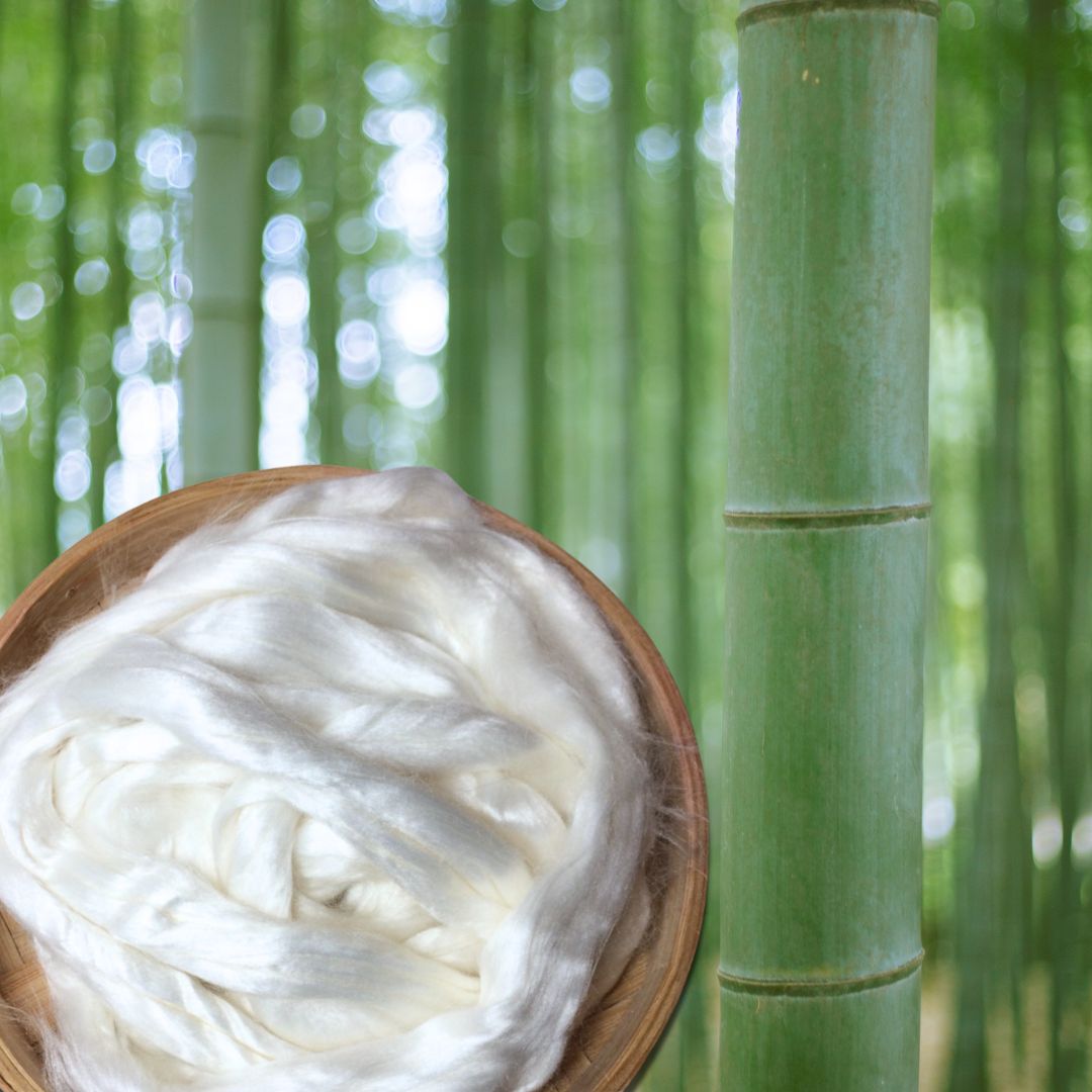 Bowl of white silk thread with a bamboo plant in the background