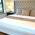 beige and white bamboo bedding on a pretty bed with tan euro pillows