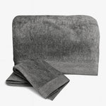 Gray towel set with folded and unfolded towel on a white background