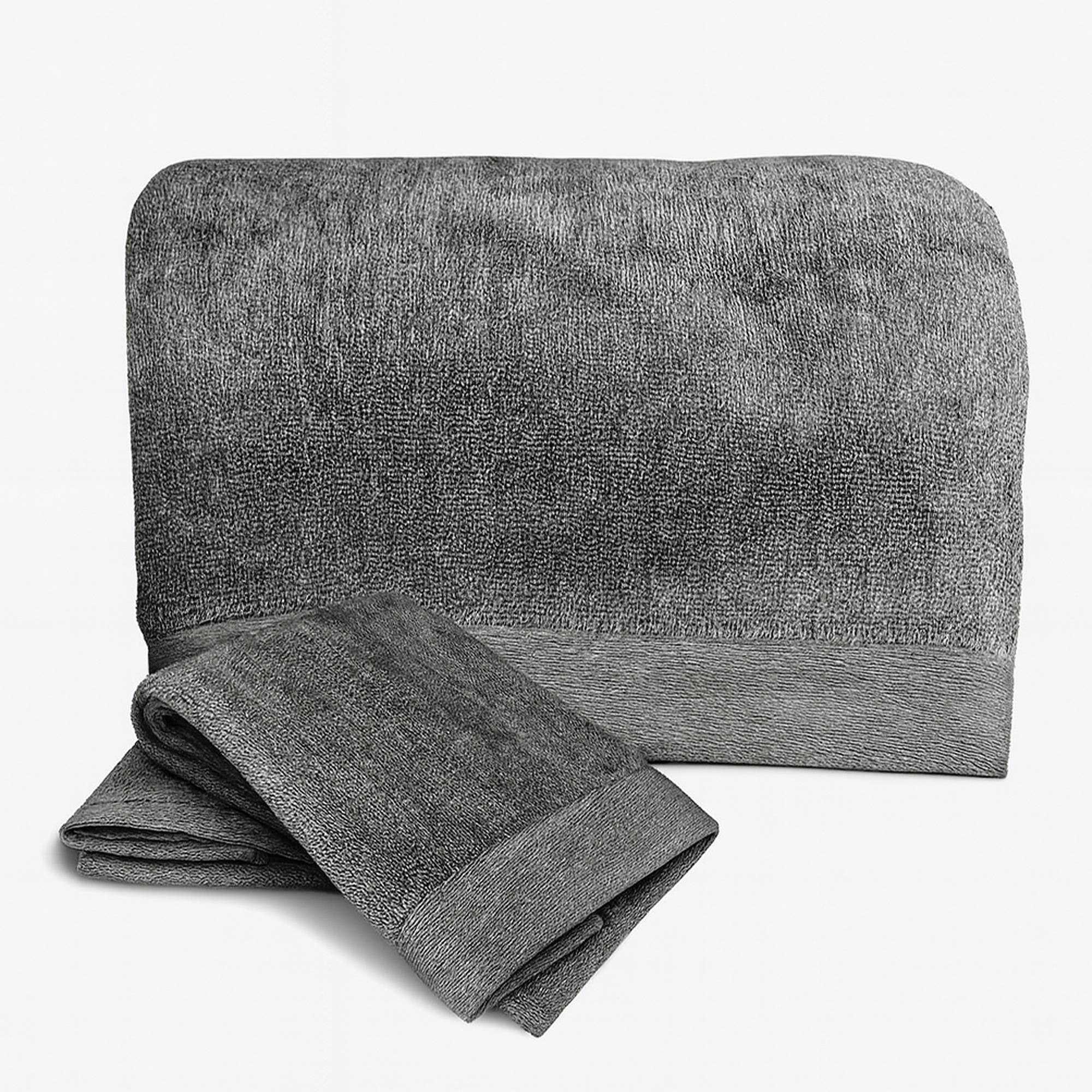 Gray towel set with folded and unfolded towel on a white background