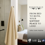Beige towel hanging in a bathroom with 'Bed Voyage' advertisement on the right.