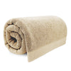 Rolled beige towel on a white background