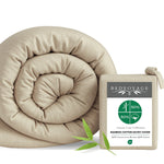 tan beige sand duvet cover rolled up with the packaging and a leaf on white background