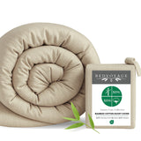 tan beige sand duvet cover rolled up with the packaging and a leaf on white background