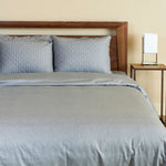 silver melange bamboo duvet cover on a bed with pillows