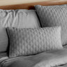 gray silver melange bamboo decorative pillow sham on a bed with brick pattern