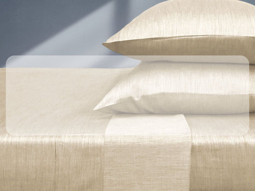 beige colored bamboo bed sheets and pillow on a bed