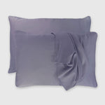 dark gray platinum bamboo pillowcases floating with one pillowcase draped over pillow