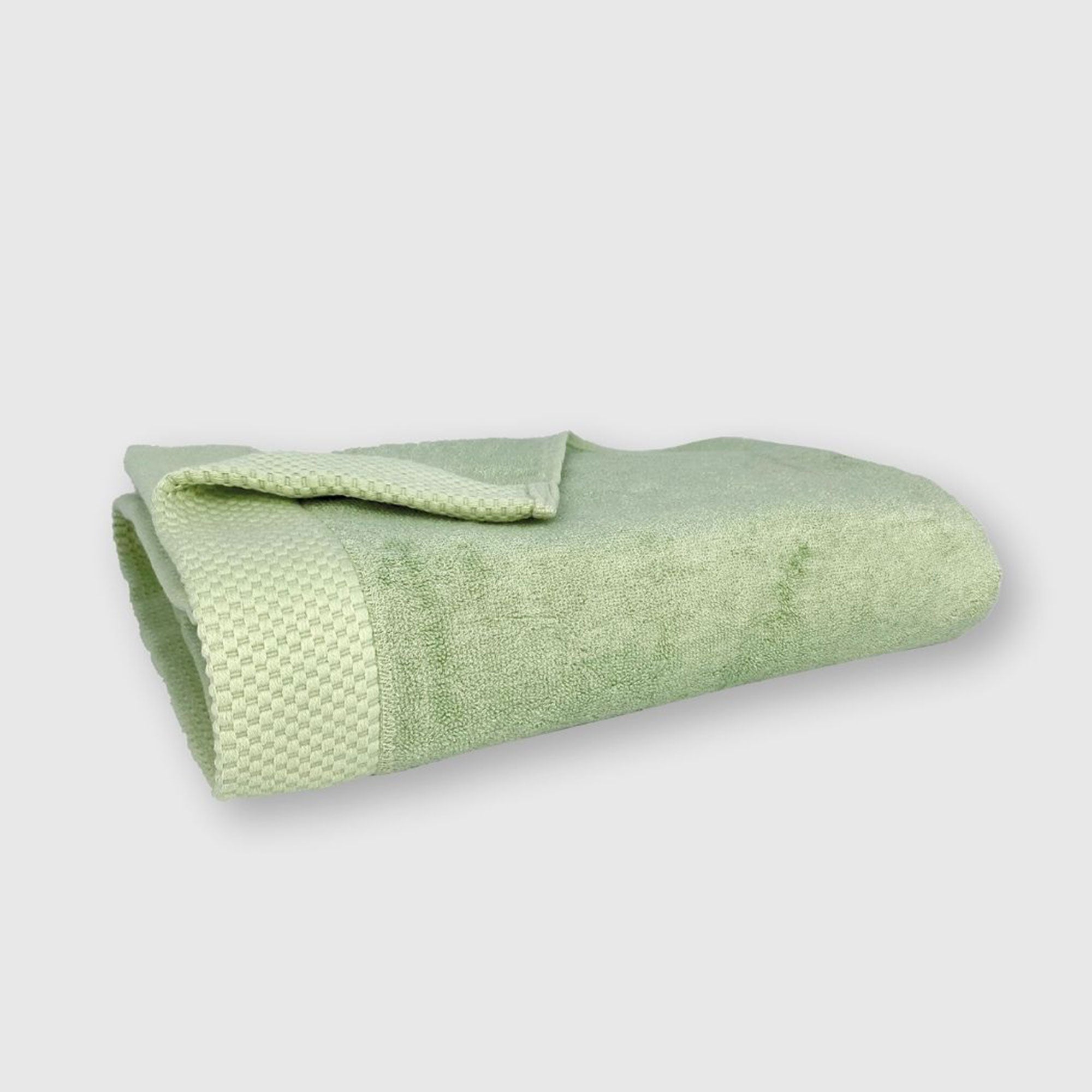 sage light green bamboo bath towel folded with basket weave edge pattern