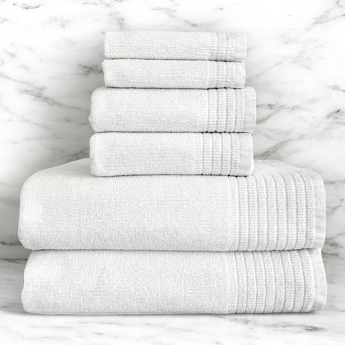6 piece White Towel Stack on bathroom counter against marble background