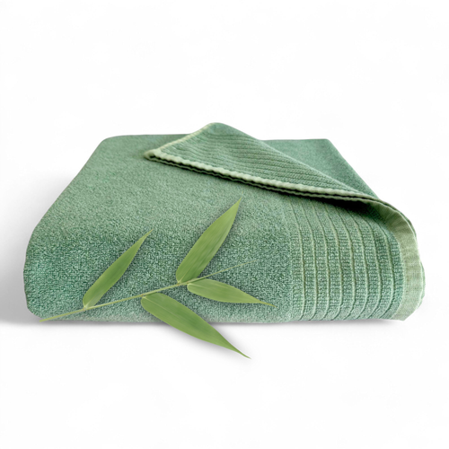 Green textured towel with bamboo leaves on a white background