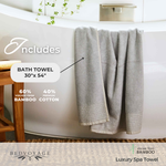 Gray bath towel hanging over a bathtub with product details and brand name.