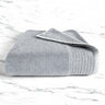 stone gray folded bamboo bath towel sitting on a marble countertop