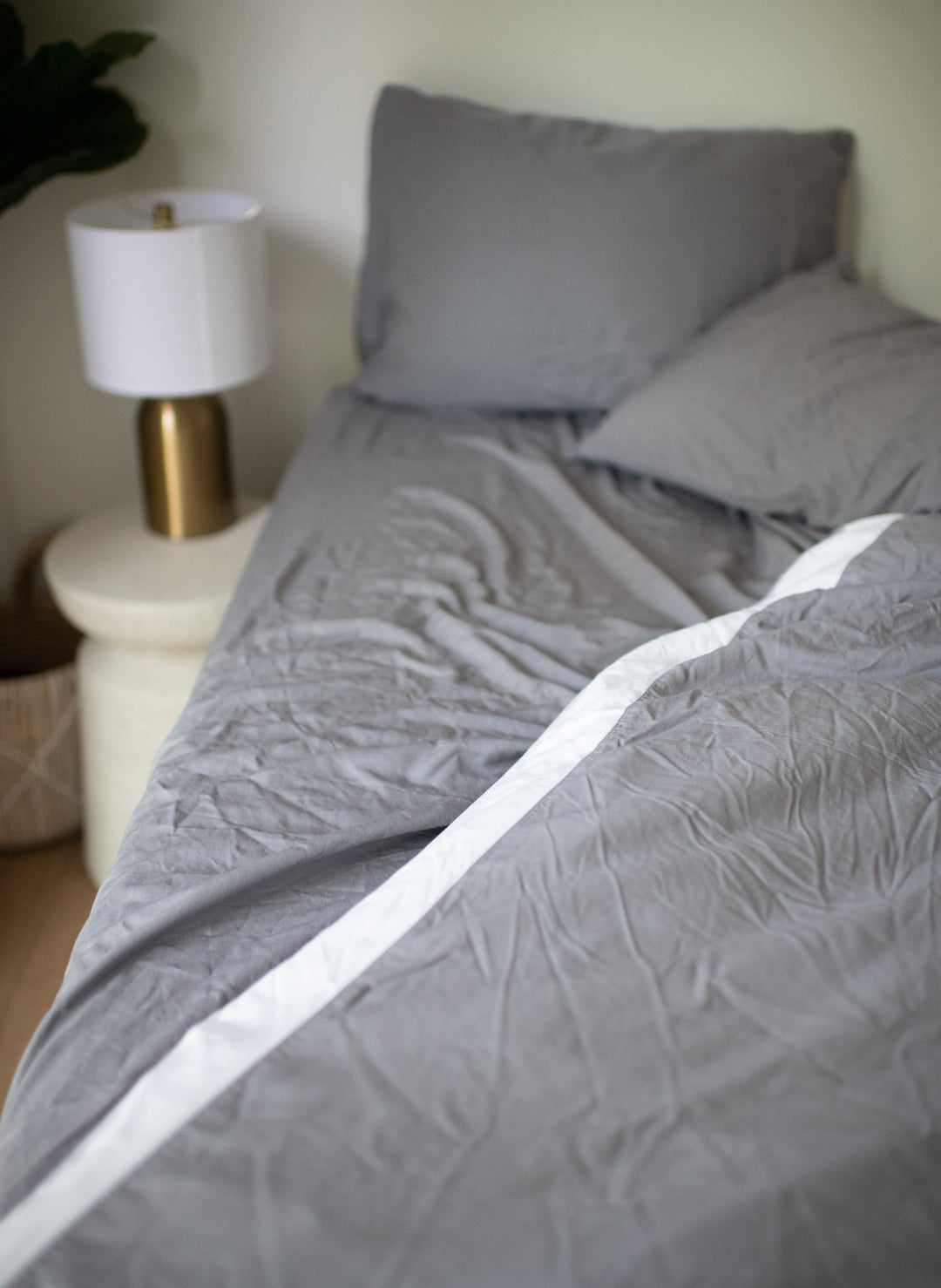 bamboo sheets in dark gray on a bed showing slight wrinkles