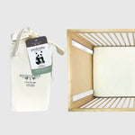 ivory bamboo crib sheet on a crib mattress with packaging image