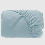 light blue sky bamboo fitted sheet with elastic showing on side of folded
